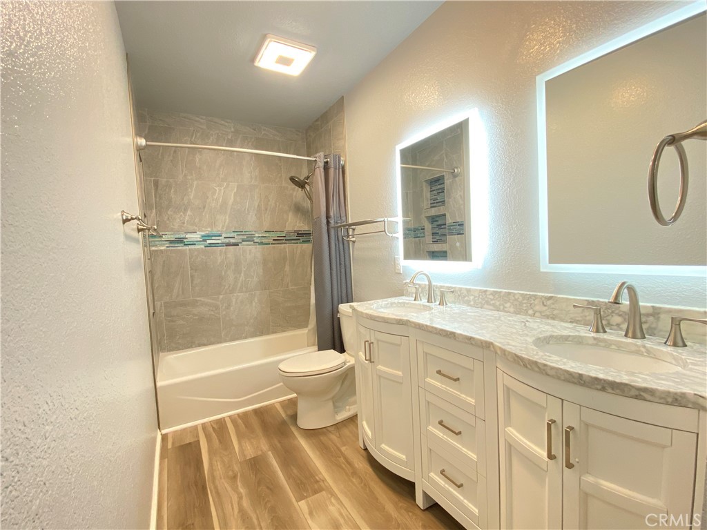971 Saltcoats Drive Riverside, CA 92508 - Photo 33 of 50 a bathroom with a granite countertop sink toilet and shower