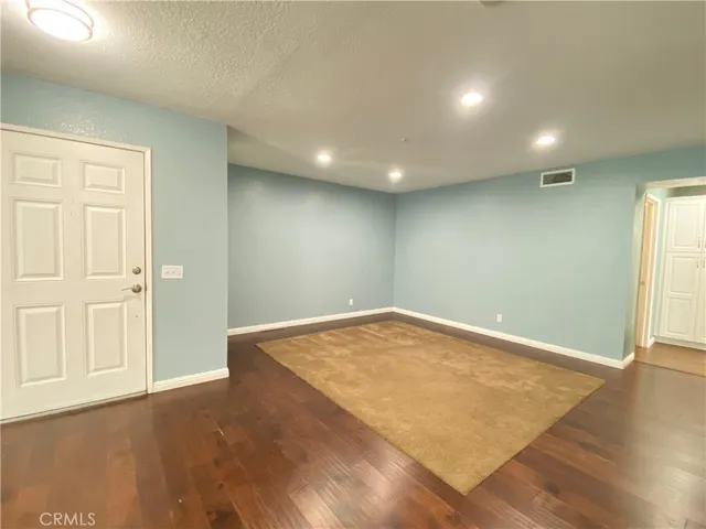 an empty room with wooden floor