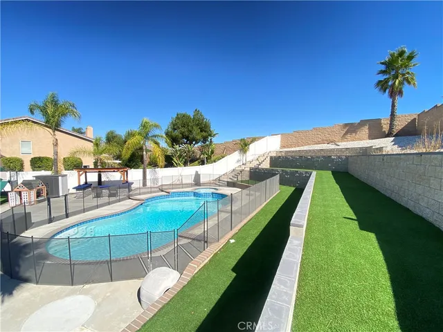 a view of a swimming pool with an outdoor seating
