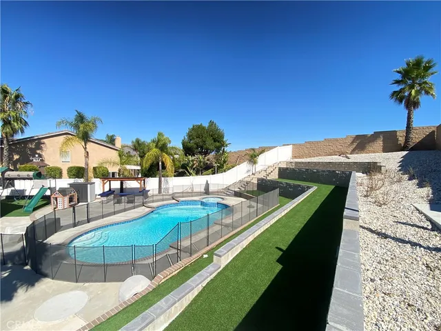 a swimming pool with outdoor seating and yard