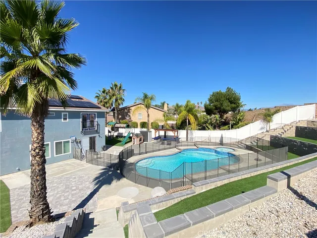 a view of a patio with swimming pool table and chairs