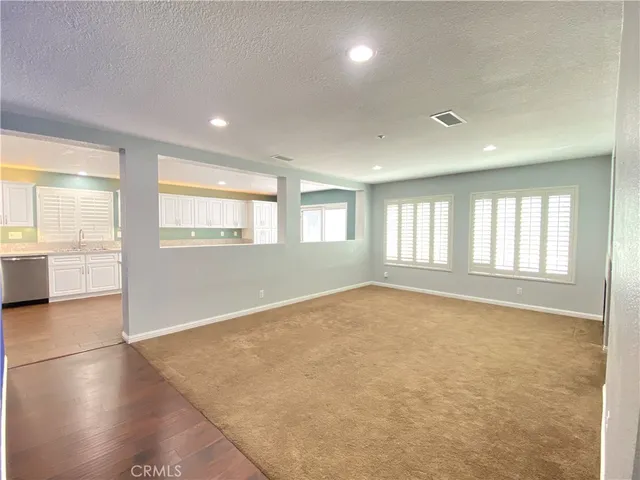 a kitchen with stainless steel appliances white cabinets and a stove top oven