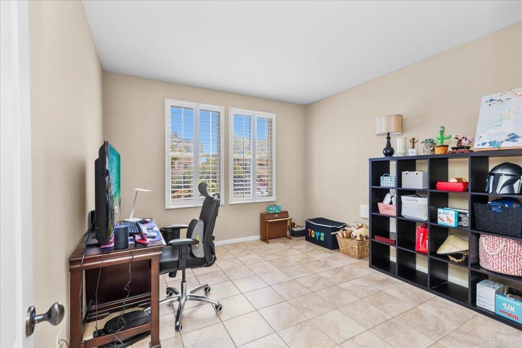 838 Luminara Way San Marcos, CA 92078 - Photo 30 of 54 a room with furniture and a book shelf