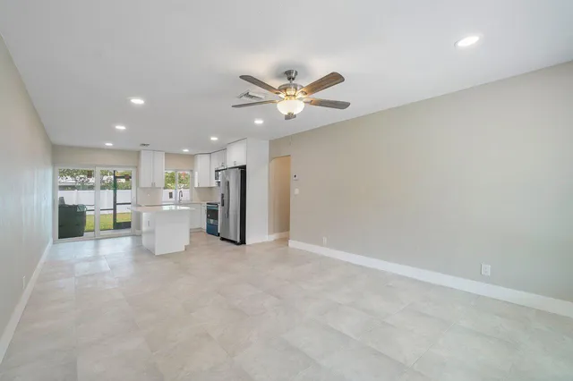 a view of a kitchen with a sink and a refrigerator