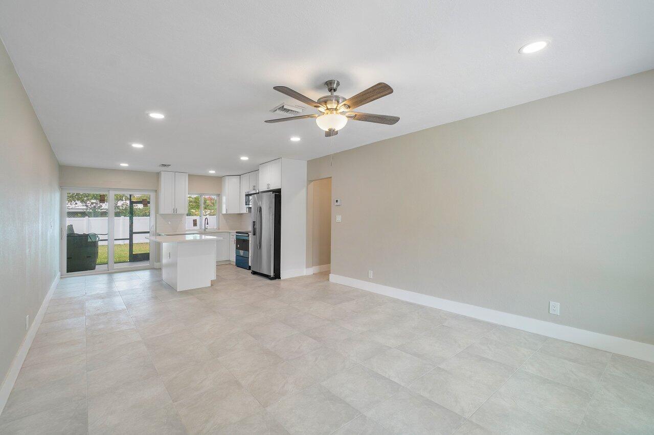 245 Southwest 6th Street Boca Raton, FL 33432 - Photo 6 of 40 a view of a kitchen with a sink and a refrigerator