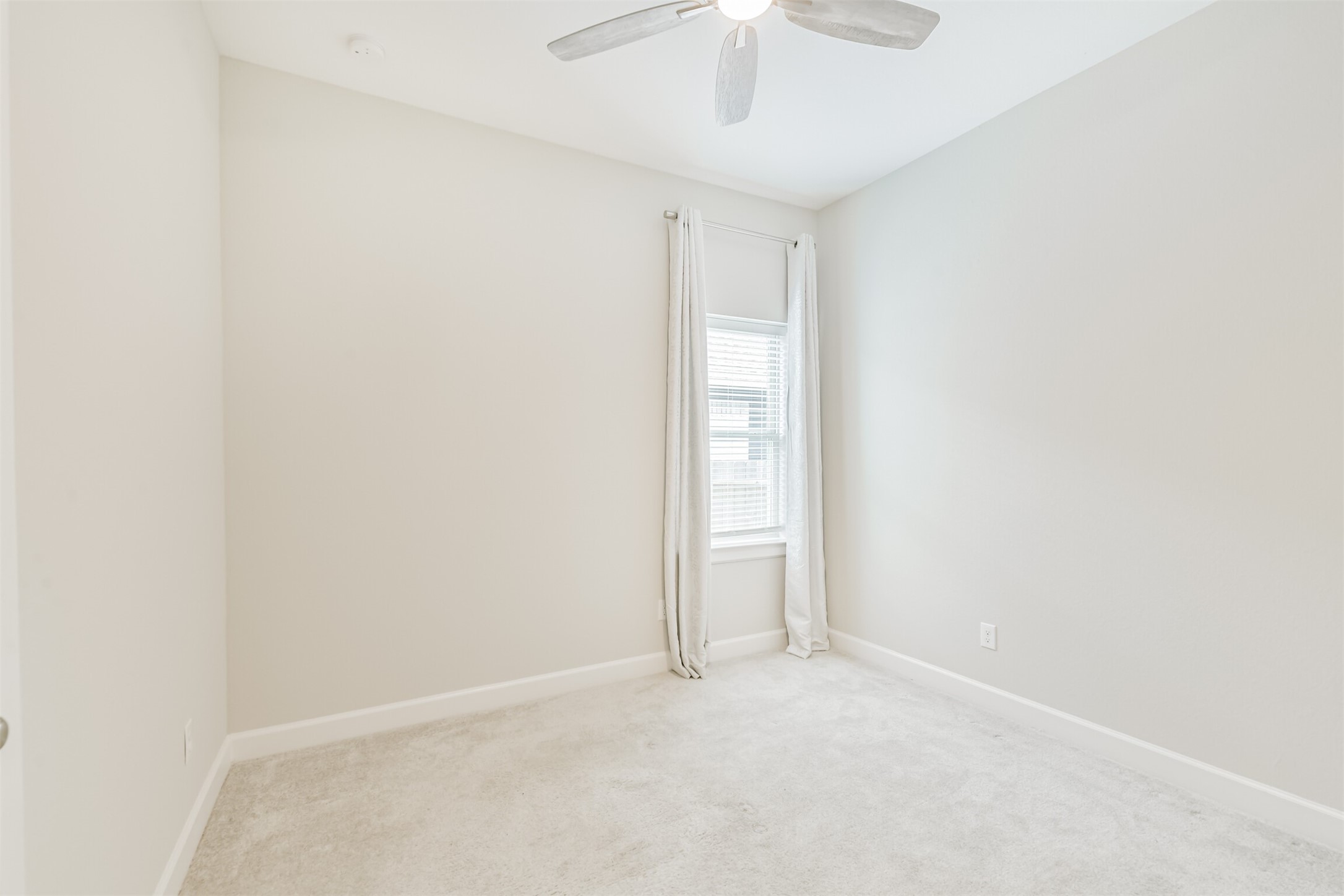 15611 Rising Wren Court Conroe, TX 77302 - Photo 35 of 38 an empty room with a empty space and a ceiling fan