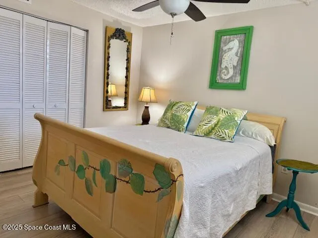 a bedroom with a bed and painting on the wall