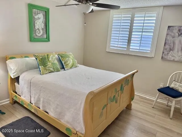 a bed sitting in a bedroom next to a window