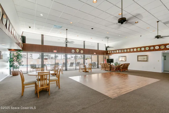 a dining hall with lots of tables and chairs