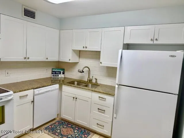 a kitchen with a sink a stove and refrigerator