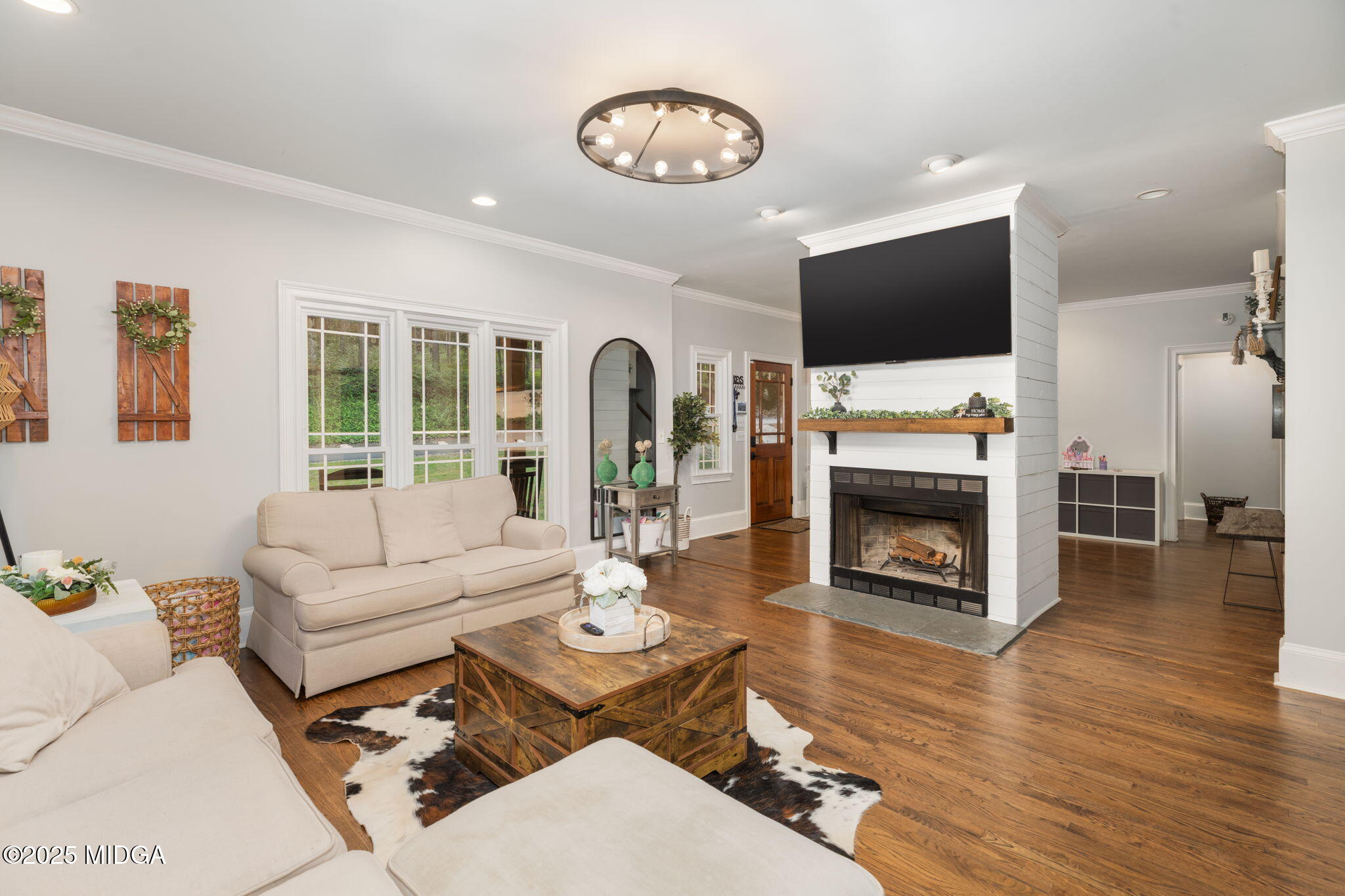 1774 Maynards Mill Road Forsyth, GA 31029 - Photo 29 of 76 a living room with furniture a flat screen tv and a fireplace