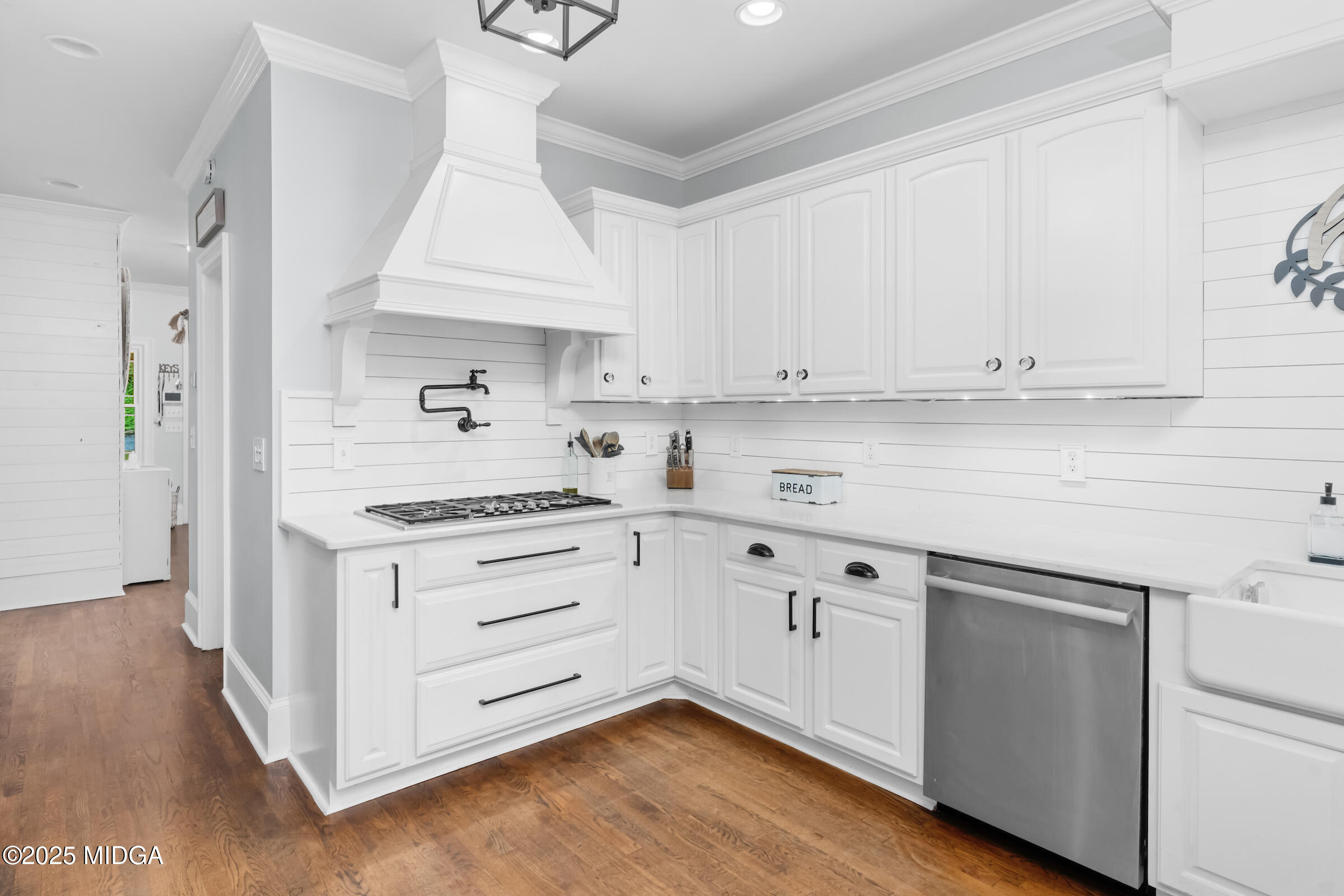 1774 Maynards Mill Road Forsyth, GA 31029 - Photo 38 of 76 a kitchen with granite countertop white cabinets and white appliances