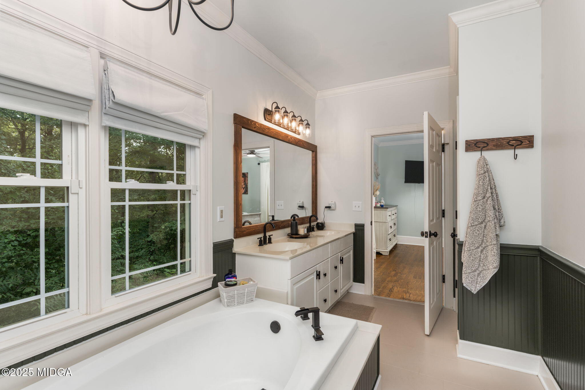 1774 Maynards Mill Road Forsyth, GA 31029 - Photo 49 of 76 a bathroom with a tub sink and mirror