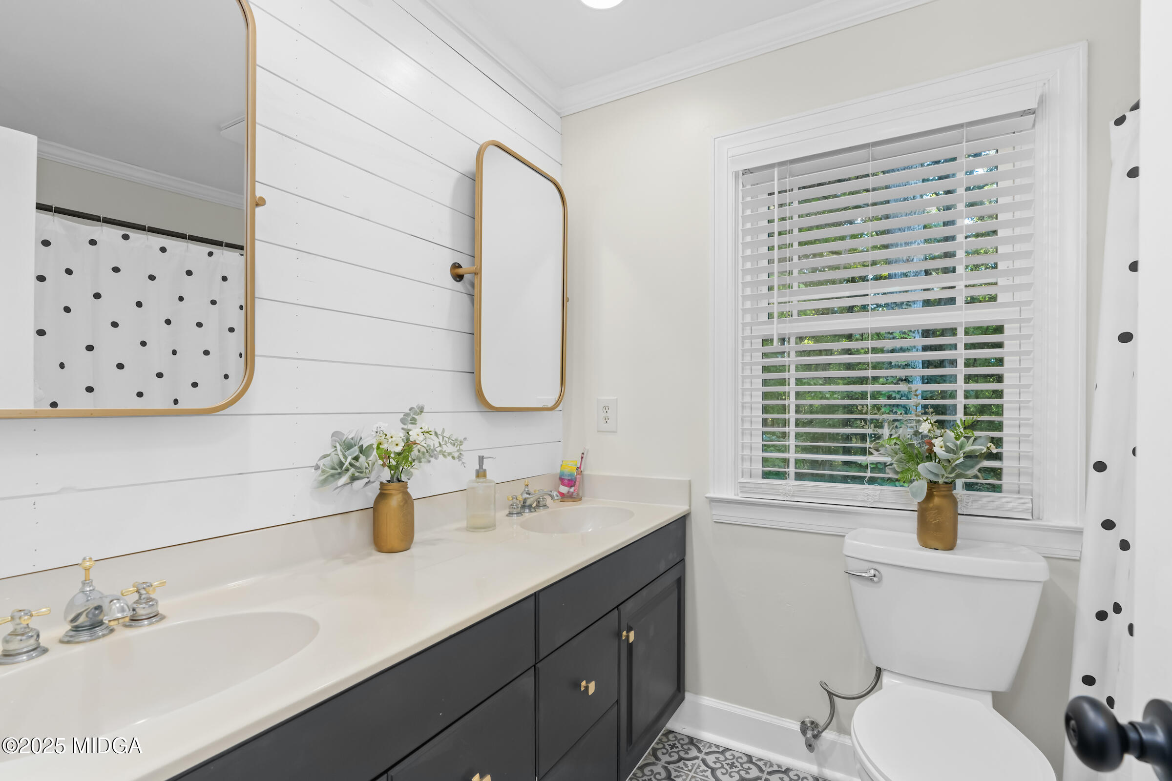1774 Maynards Mill Road Forsyth, GA 31029 - Photo 56 of 76 a bathroom with a sink a mirror a toilet and a window
