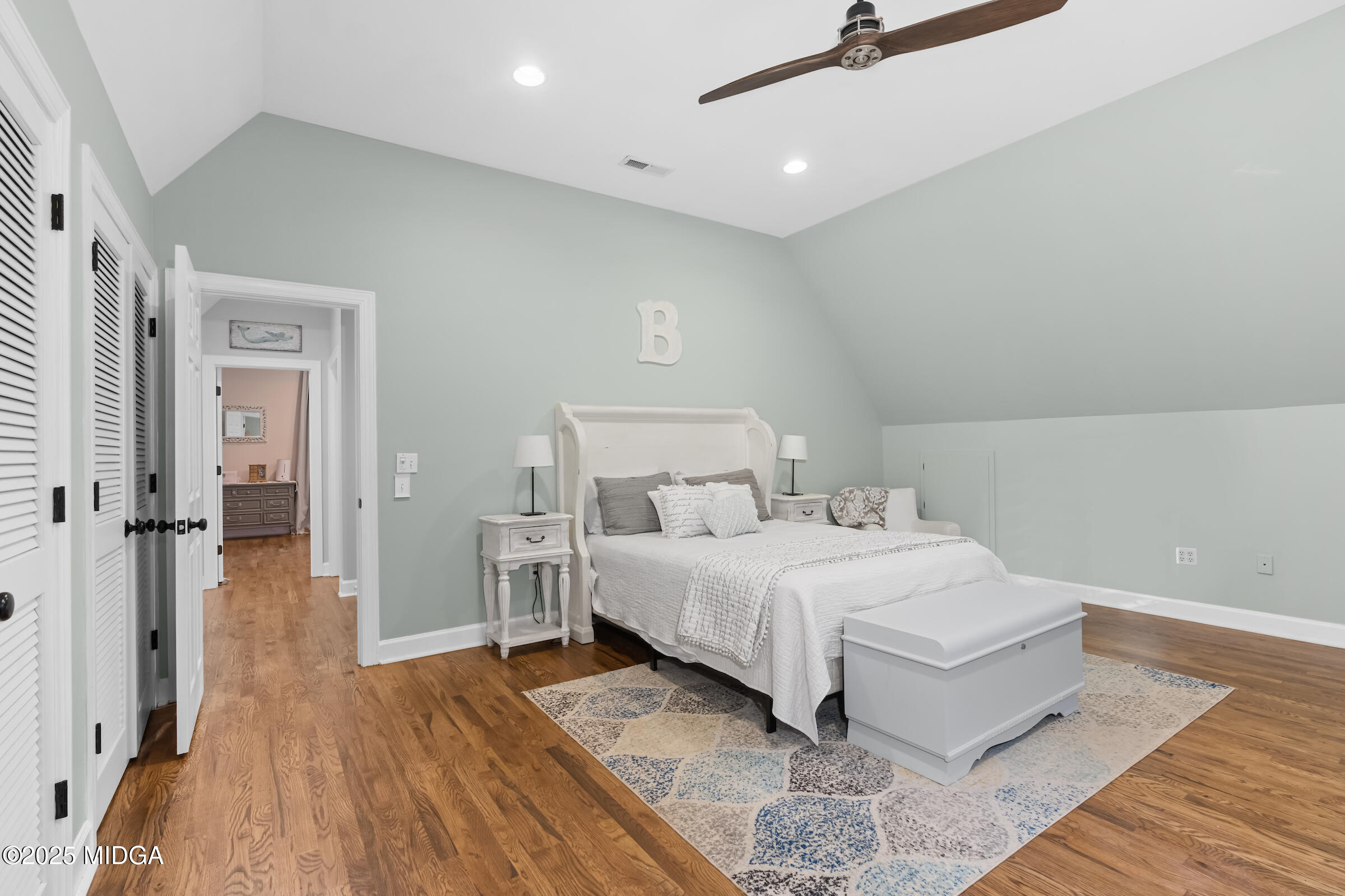 1774 Maynards Mill Road Forsyth, GA 31029 - Photo 58 of 76 a spacious bedroom with a bed and a wooden floor