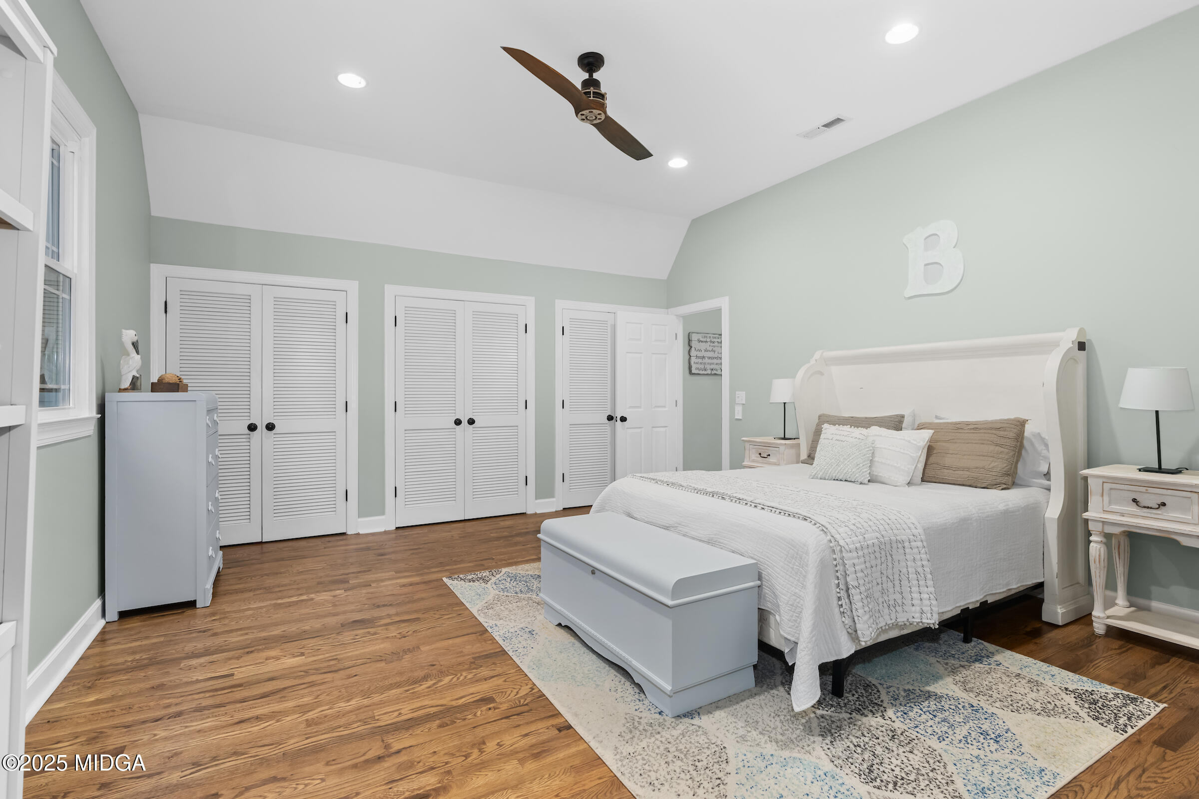 1774 Maynards Mill Road Forsyth, GA 31029 - Photo 59 of 76 a spacious bedroom with a bed and a walk in closet