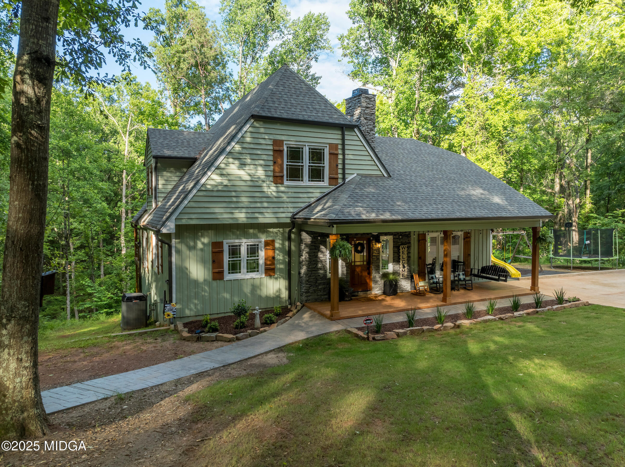 1774 Maynards Mill Road Forsyth, GA 31029 - Photo 6 of 76 a front view of a house with a yard table and chairs