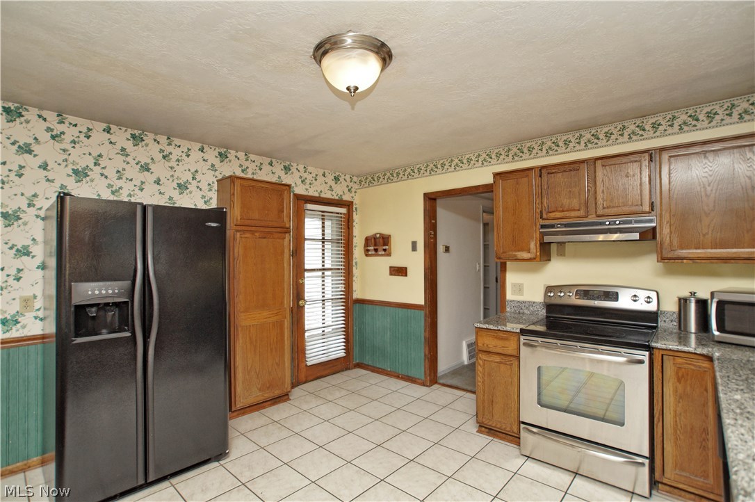 1273 Ford Road Lyndhurst, OH 44124 - Photo 13 of 32 Spacious Kitchen with lots of cabinets, ceramic tiled floors and granite counters.