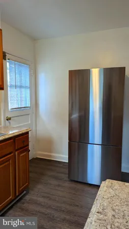 a kitchen with wooden floors and wooden cabinets