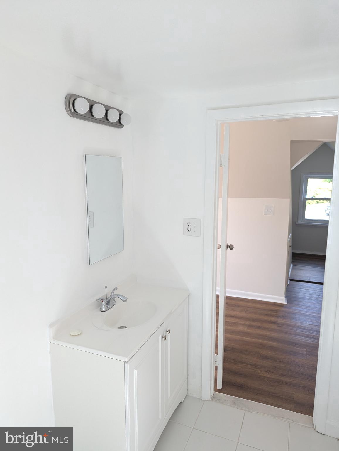 2700 Dawson Avenue Silver Spring, MD 20902 - Photo 10 of 11 a bathroom with a sink a toilet and mirror