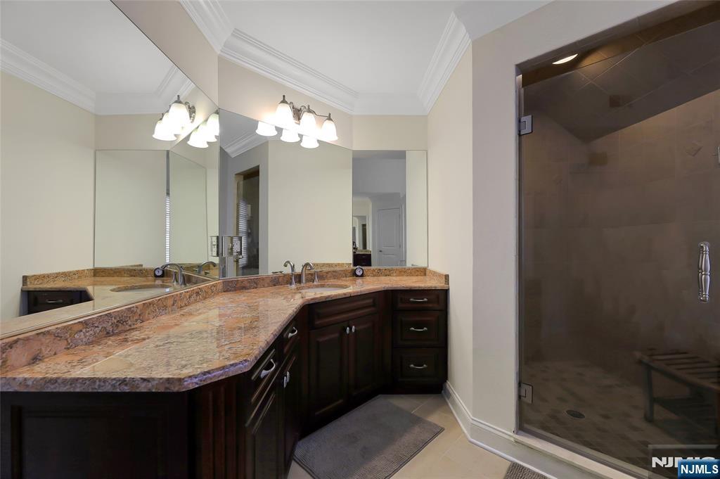 22 Meadowlake Drive Mahwah, NJ 07430 - Photo 33 of 39 a bathroom with a granite countertop sink a toilet and a mirror