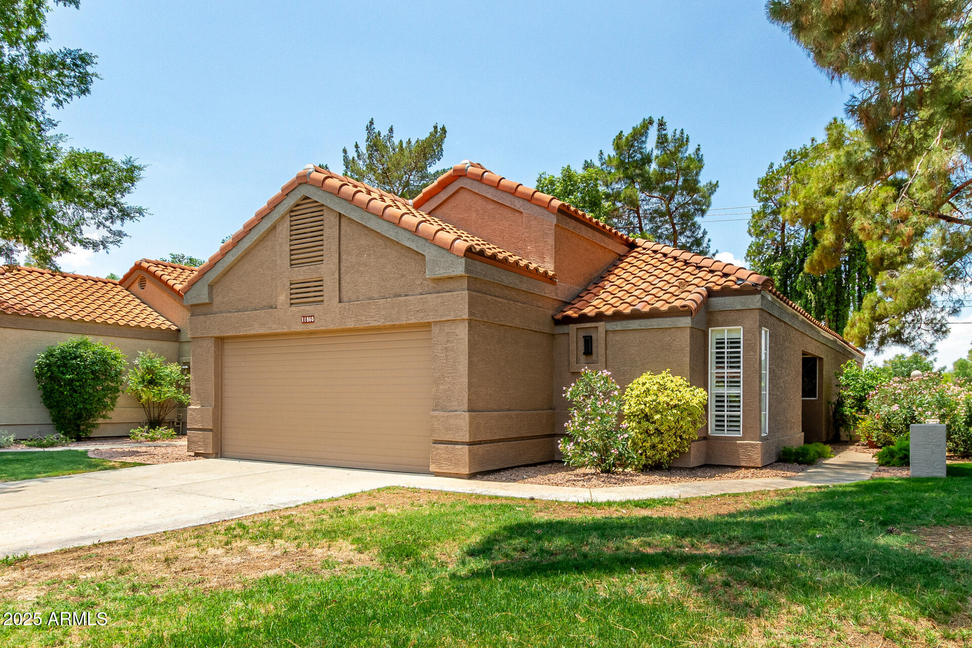 a front view of a house with a garden