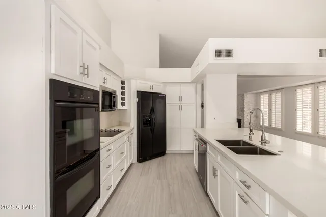 a kitchen with stainless steel appliances a refrigerator and a sink