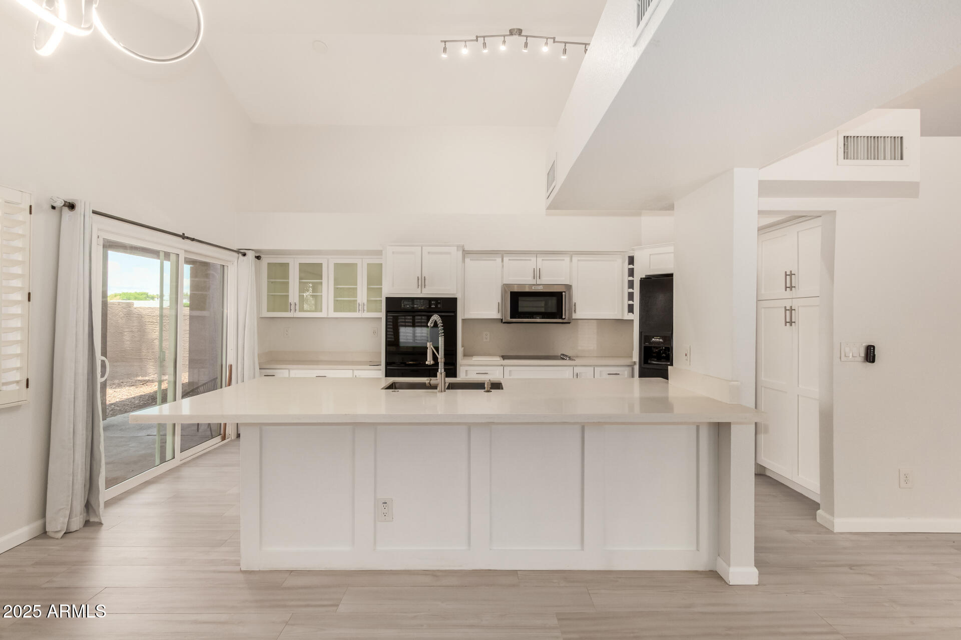 11860 North 40th Way Phoenix, AZ 85028 - Photo 12 of 31 a large white kitchen with wooden floor and a sink