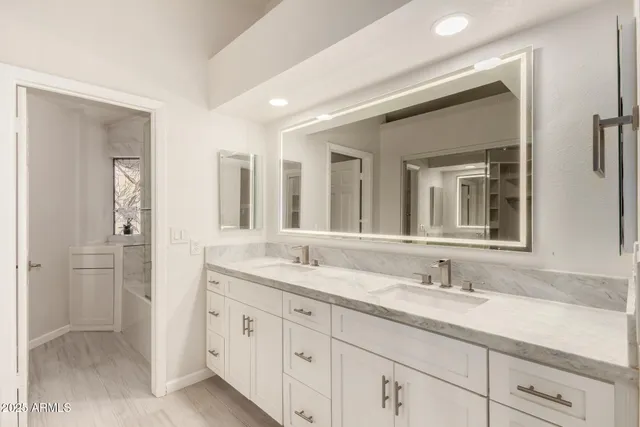 a bathroom with a granite countertop sink double and mirror