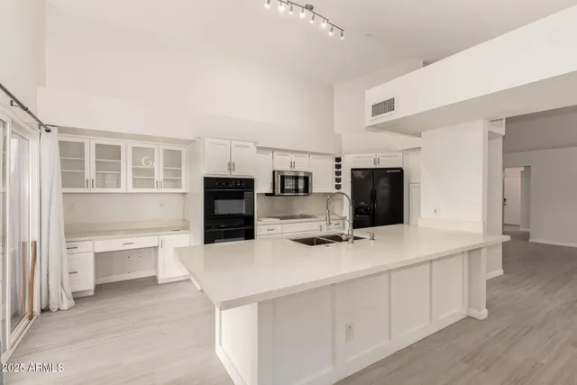 a kitchen with stainless steel appliances a refrigerator and a stove top oven