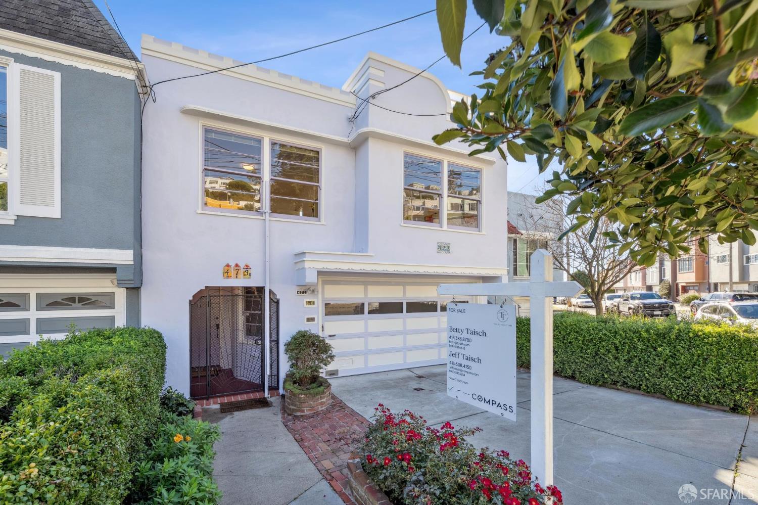 front view of a house with a garden