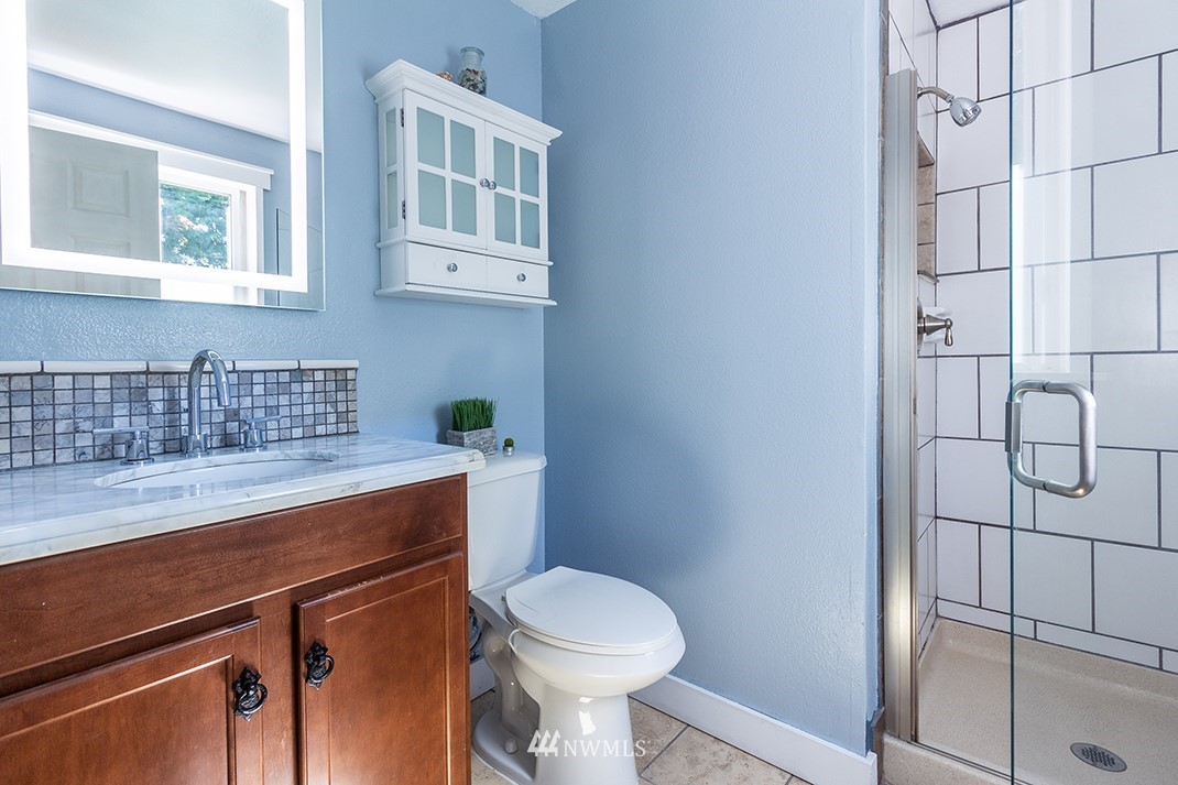 10025 Northeast 204th Street Bothell, WA 98011 - Photo 21 of 40 a bathroom with a sink a toilet and shower