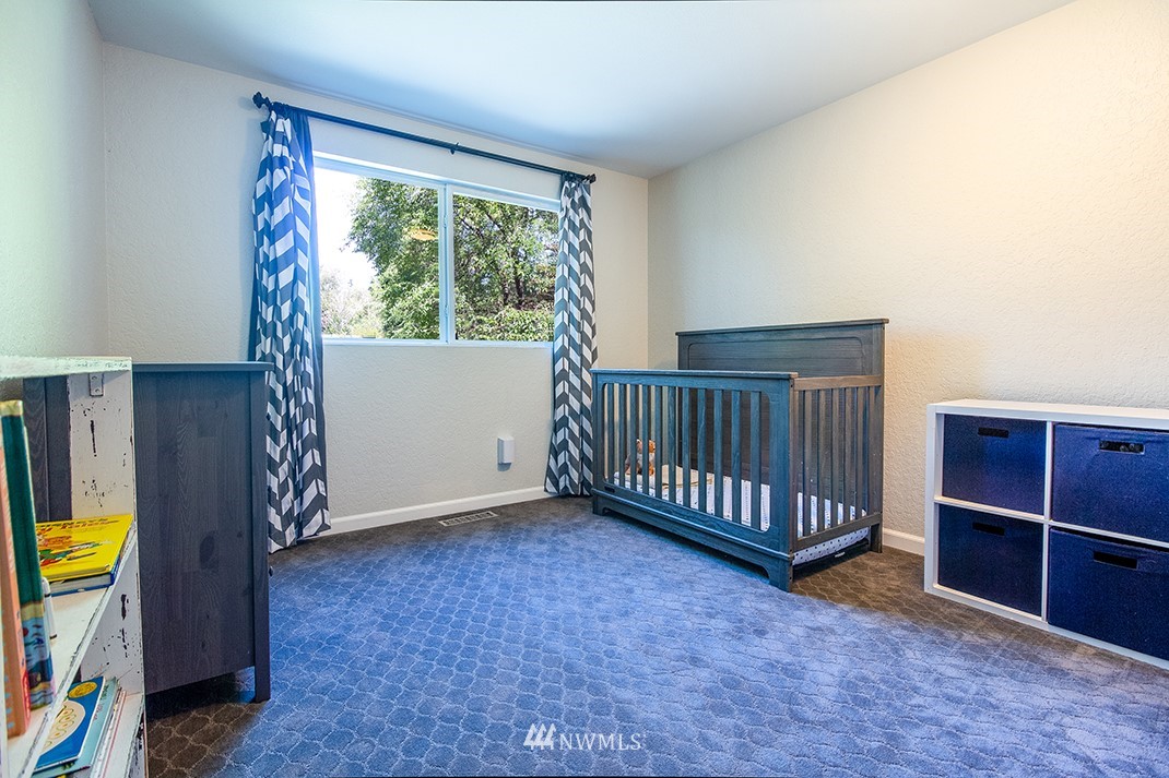 10025 Northeast 204th Street Bothell, WA 98011 - Photo 24 of 40 a view of a bedroom with furniture and staircase