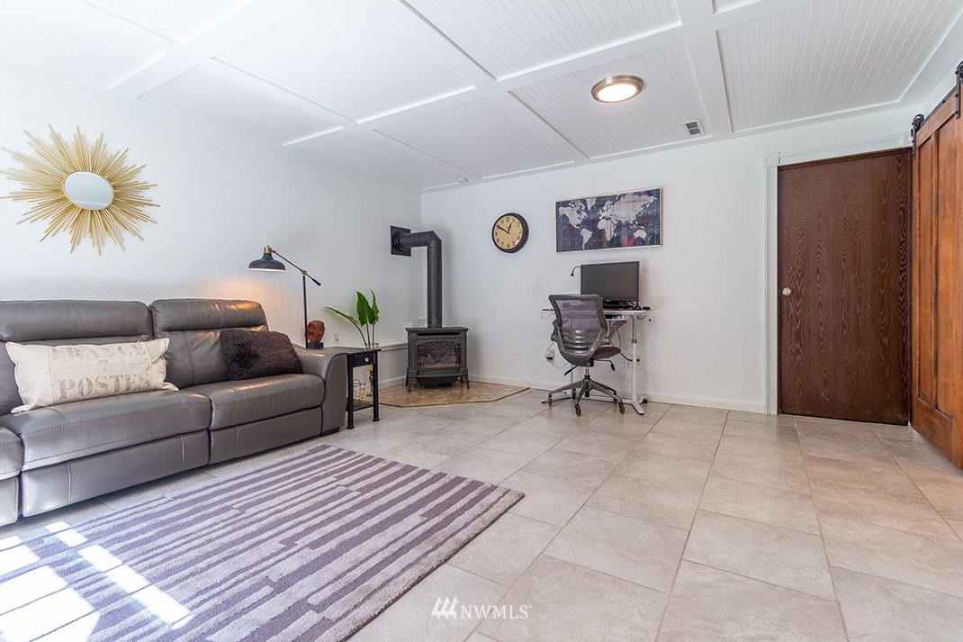 10025 Northeast 204th Street Bothell, WA 98011 - Photo 29 of 40 a living room with furniture and a rug