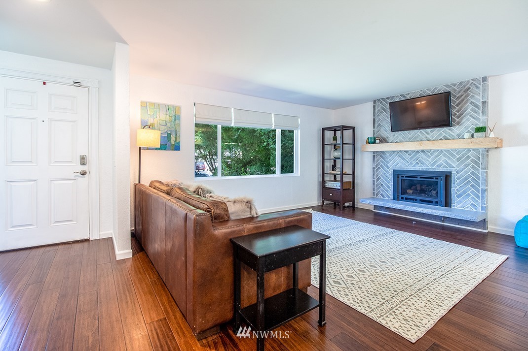 10025 Northeast 204th Street Bothell, WA 98011 - Photo 7 of 40 a living room with furniture and a fireplace
