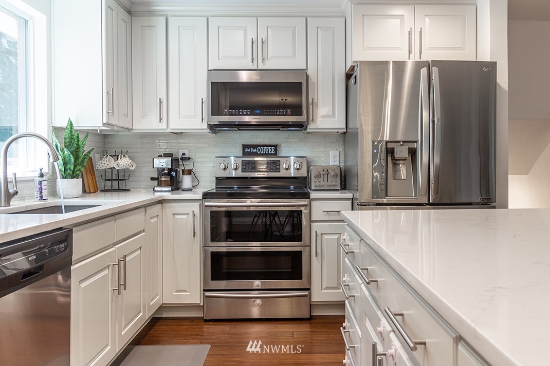 10025 Northeast 204th Street Bothell, WA 98011 - Photo 10 of 40 a kitchen with a refrigerator stove and microwave