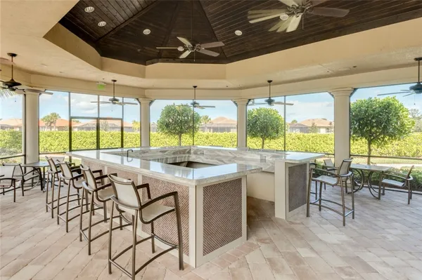 a large kitchen with a large island lots of appliances and furniture