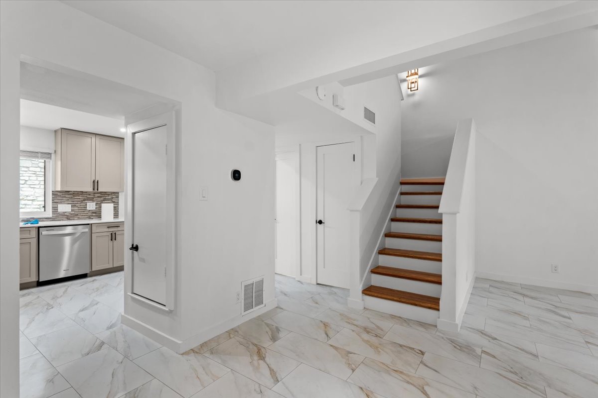 2500 Enfield Road, Unit 1 Austin, TX 78703 - Photo 10 of 26 Clean lines and a striking wood staircase define this contemporary interior, boasting elegant tile flooring throughout.