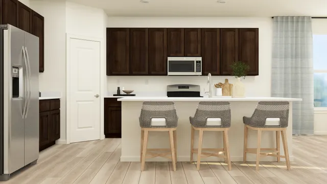 a kitchen with stainless steel appliances granite countertop a stove a microwave a sink and a refrigerator