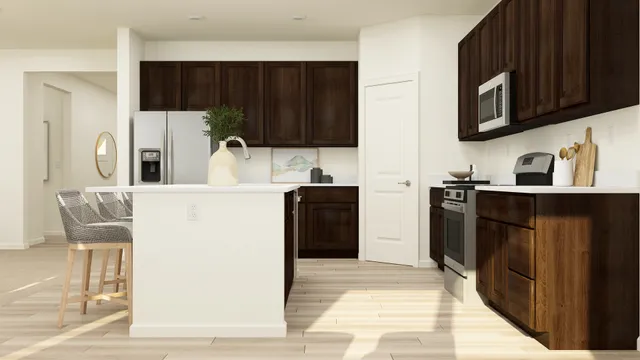 a kitchen with stainless steel appliances a sink cabinets and a refrigerator