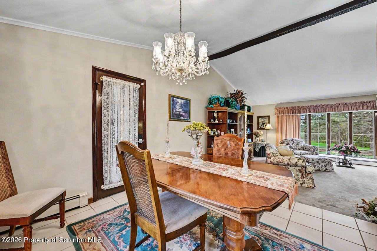 73 Quinton Road Scott Township, PA 18447 - Photo 14 of 64 a dining room with furniture a chandelier and window