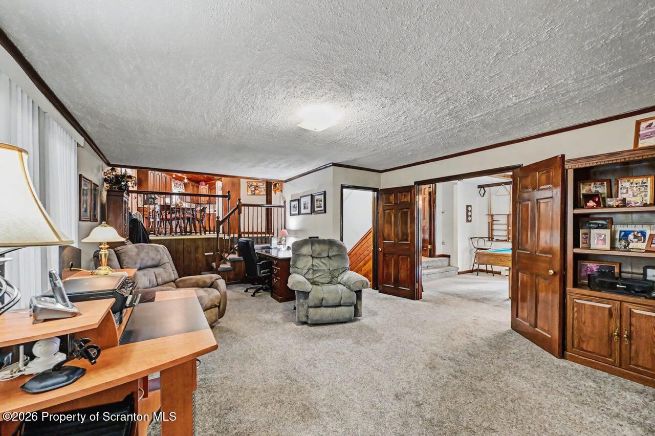 73 Quinton Road Scott Township, PA 18447 - Photo 23 of 64 a living room with furniture a large window and bookshelf