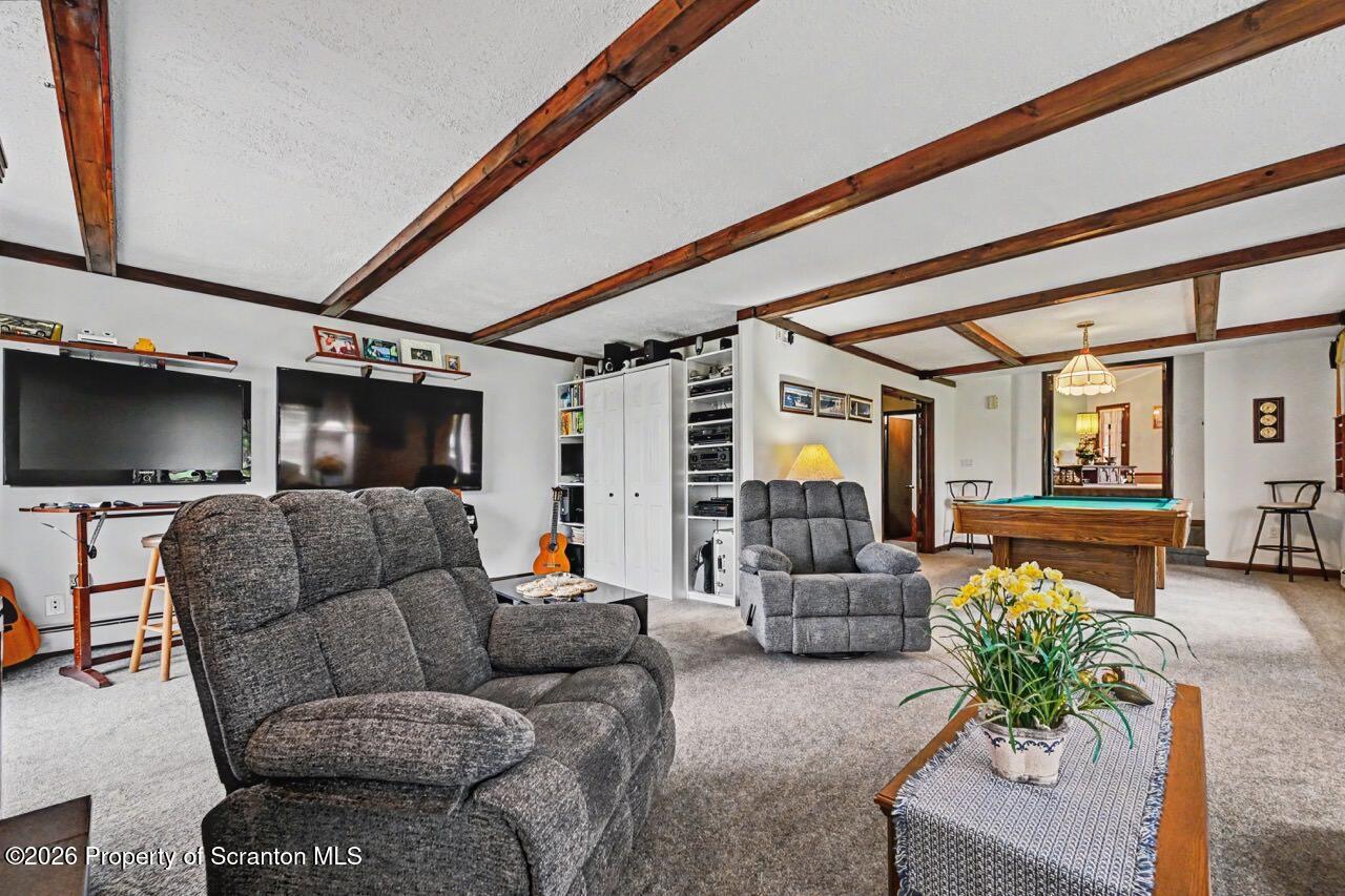 73 Quinton Road Scott Township, PA 18447 - Photo 29 of 64 a living room with furniture and a flat screen tv