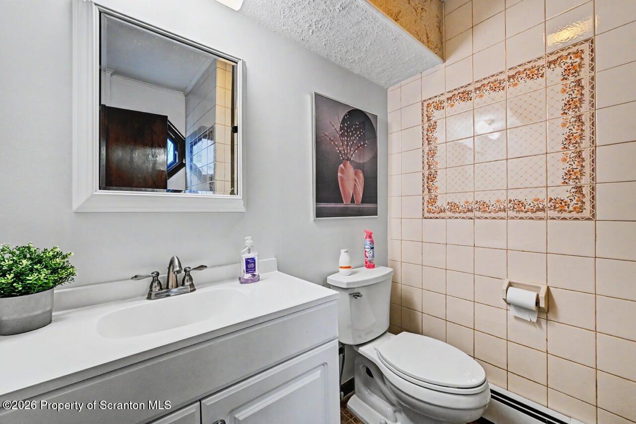 73 Quinton Road Scott Township, PA 18447 - Photo 32 of 64 a bathroom with a toilet sink and mirror
