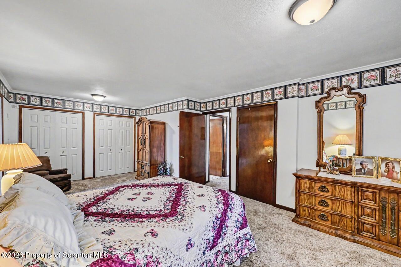 73 Quinton Road Scott Township, PA 18447 - Photo 39 of 64 a bedroom with a bed a dresser and a window