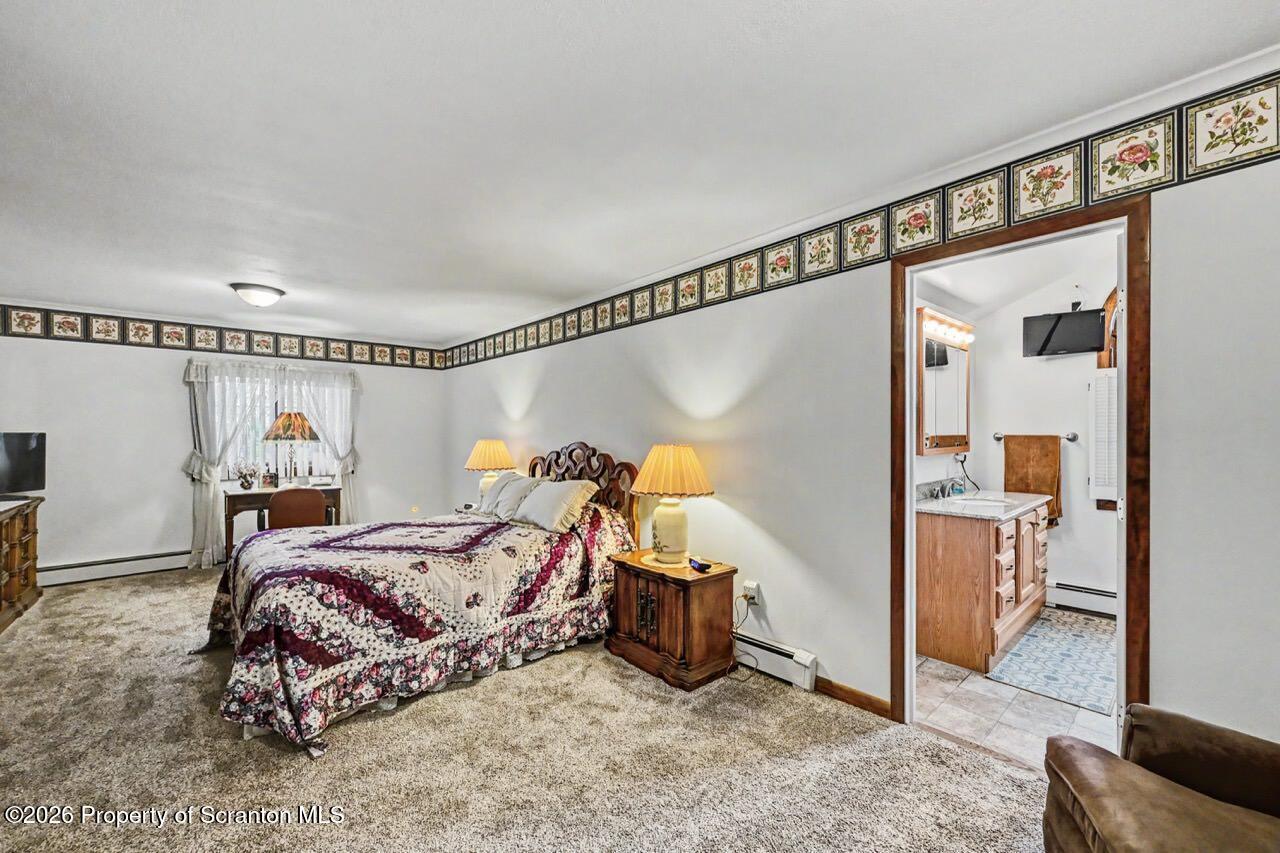 73 Quinton Road Scott Township, PA 18447 - Photo 40 of 64 a bedroom with a bed and a mirror
