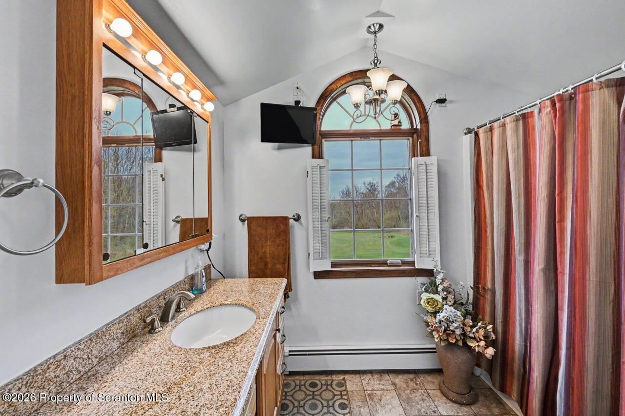 73 Quinton Road Scott Township, PA 18447 - Photo 41 of 64 a bathroom with a granite countertop sink and a mirror