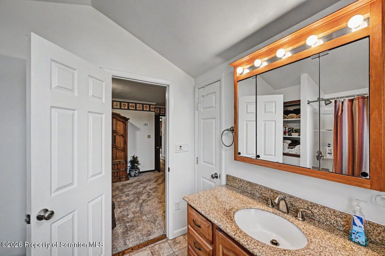 73 Quinton Road Scott Township, PA 18447 - Photo 42 of 64 a bathroom with a granite countertop sink and a mirror