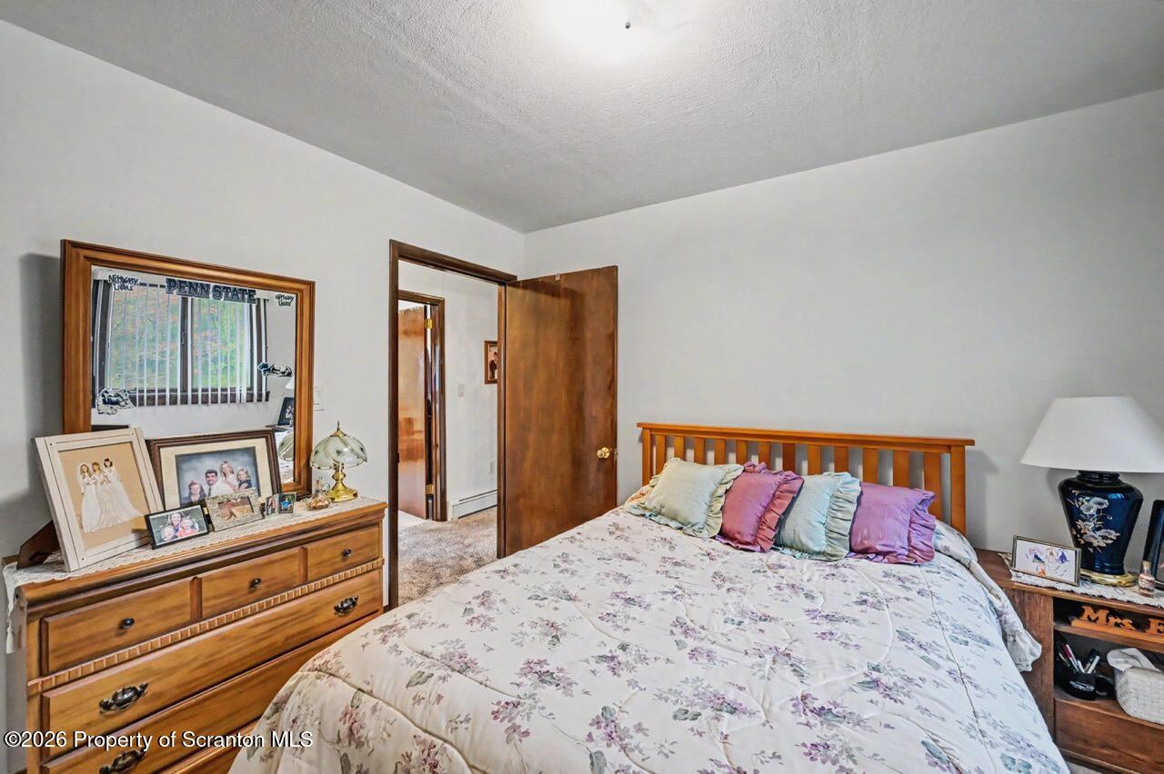 73 Quinton Road Scott Township, PA 18447 - Photo 48 of 64 a bedroom with a bed and wooden floor