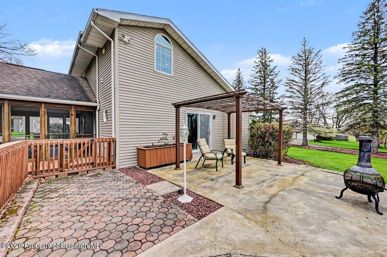 73 Quinton Road Scott Township, PA 18447 - Photo 57 of 64 a backyard of a house with barbeque oven table and chairs